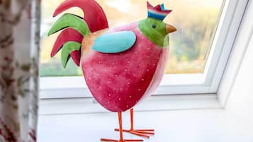 Eine bunte Hahnschmuck auf einer Fensterbank.