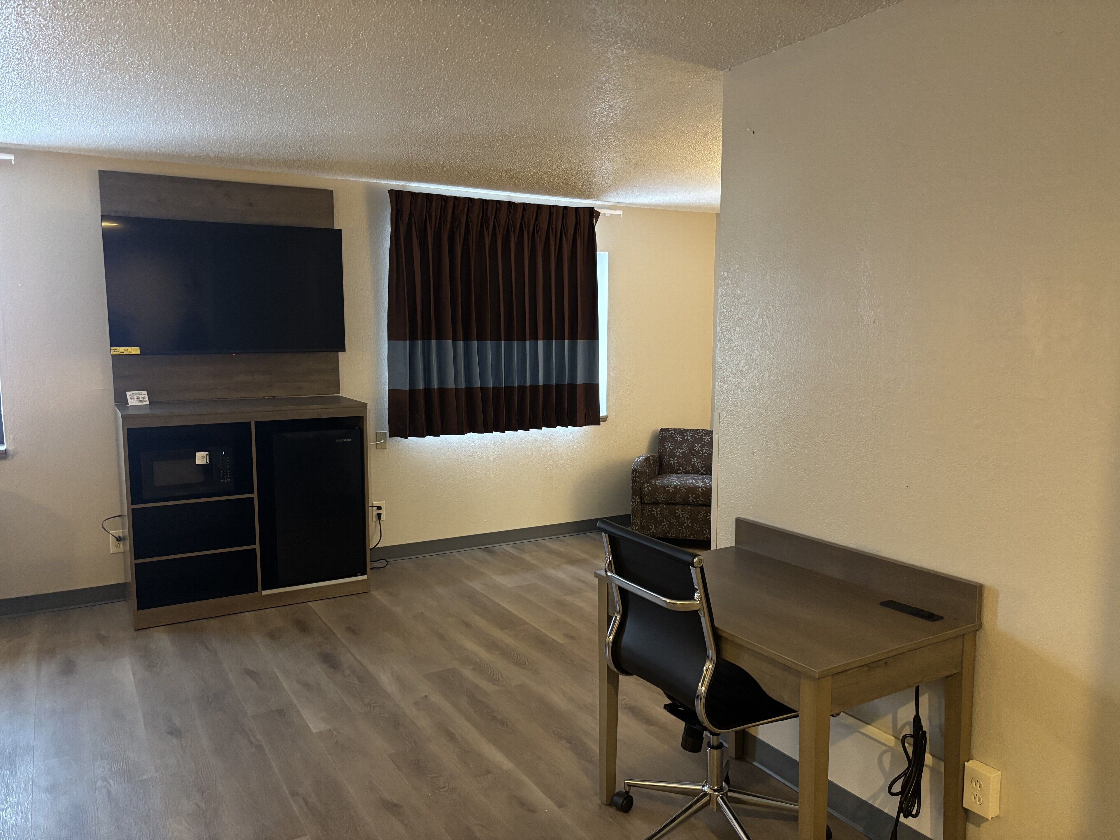 Suite, 1 King Bed, Non Smoking | Desk, laptop workspace, blackout curtains, iron/ironing board