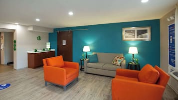 Relax in a cozy seating area with a sofa and armchairs, perfect for unwinding.