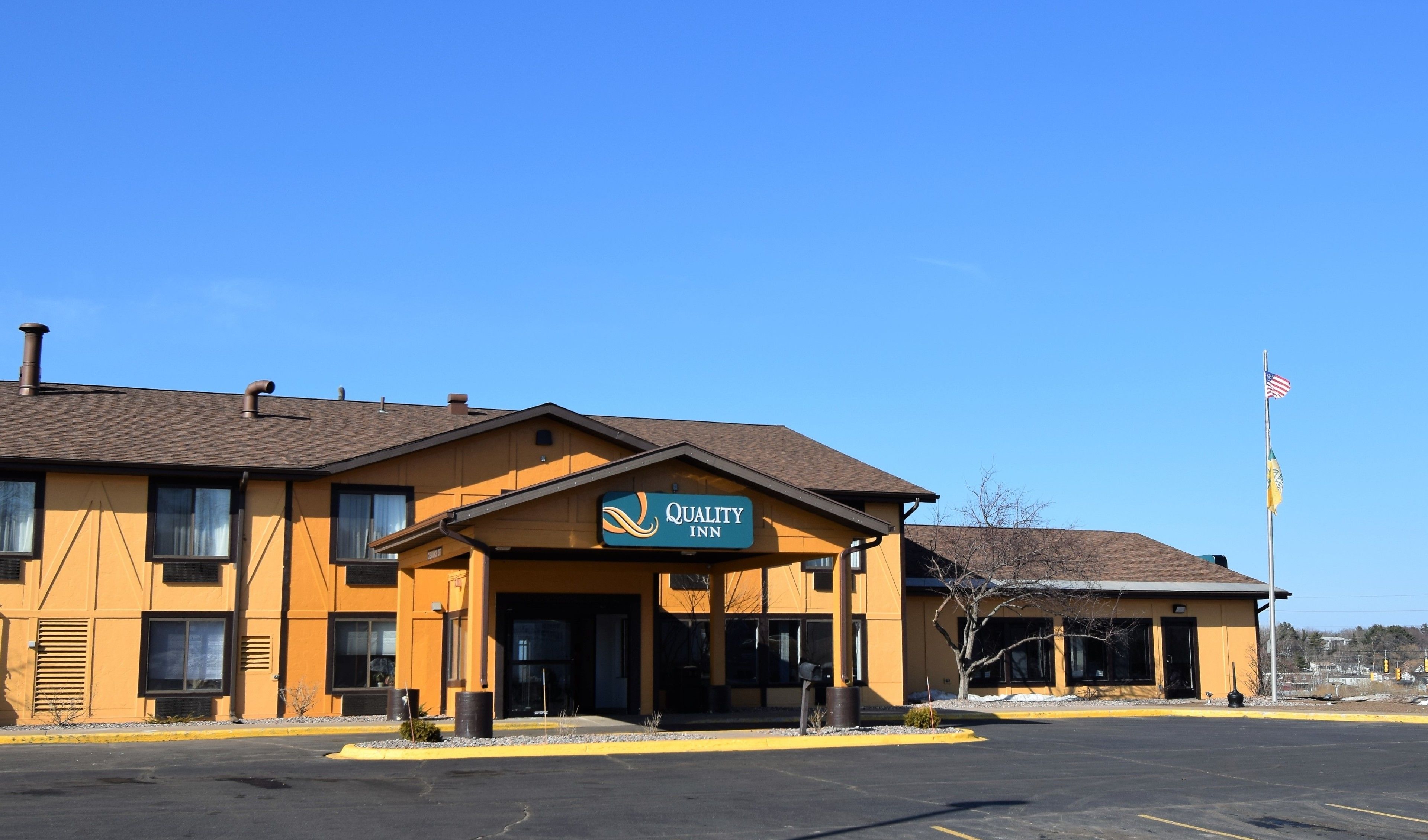 A two-story building with a sign reading "Quality Inn".