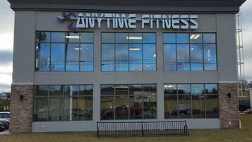 A building with a sign reading "ANYTIME FITNESS".