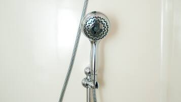 A shower with a handheld showerhead and a flexible hose.