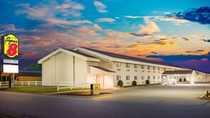 A Super 8 motel with a large building, indoor pool, and a well-lit entrance. - Super 8 by Wyndham Nevada (Nevada)
