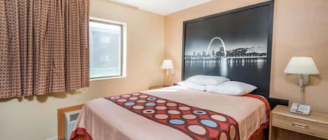 A hotel room with a bed, a window with curtains, a wall-mounted lamp, and a cityscape poster.