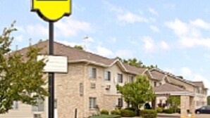 A hotel with a stone facade, multiple windows, and a sign indicating it is a RIVERVIEW hotel.