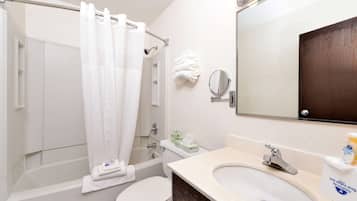 A bathroom with a bathtub, toilet, and sink.