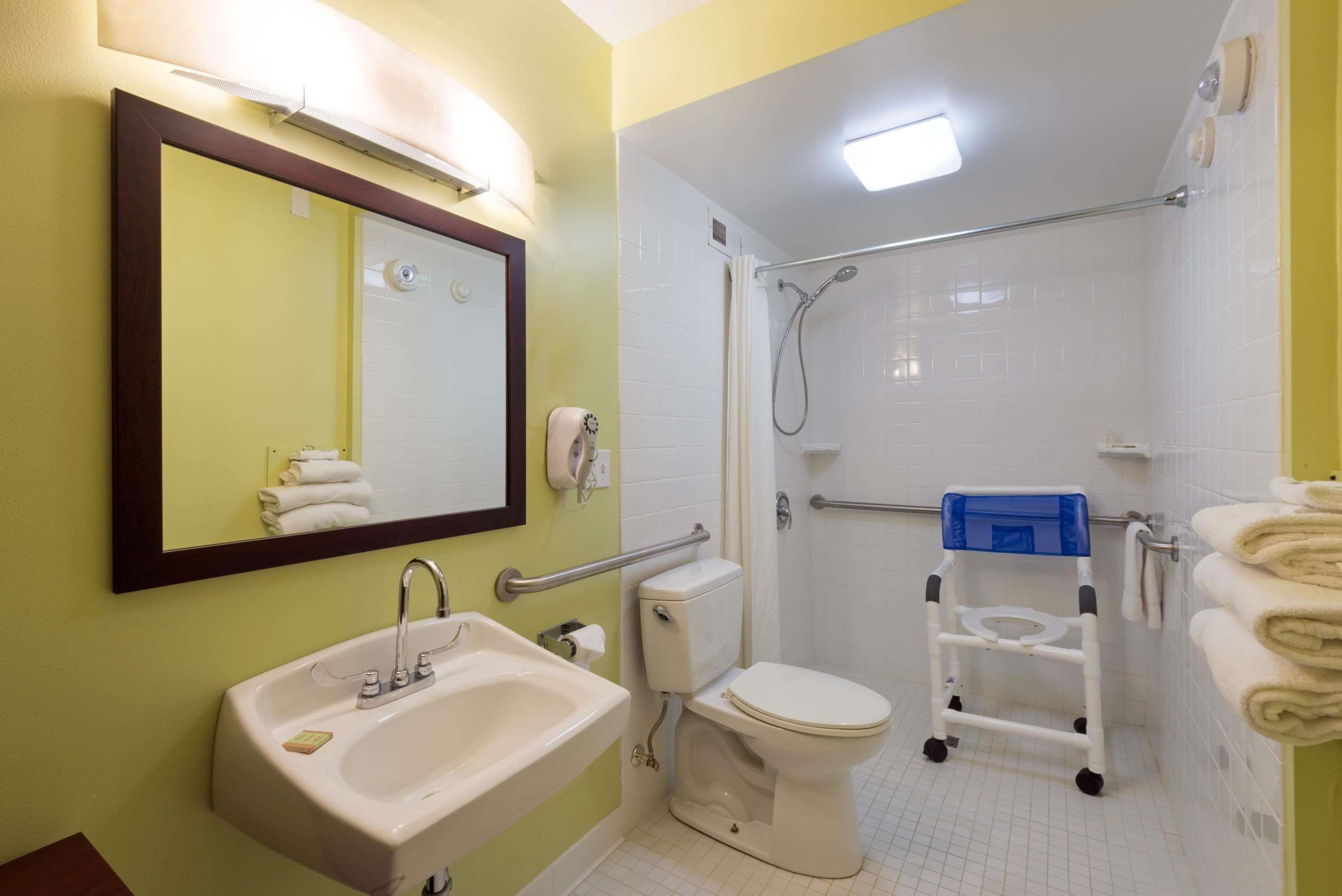A bathroom with a sink, toilet, and shower.