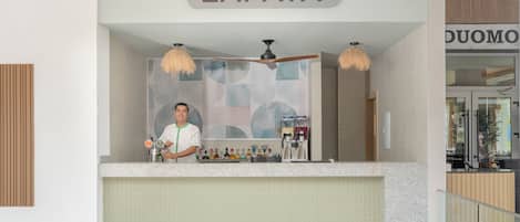 A reception area with a sign reading "ZAPATA" above a counter.