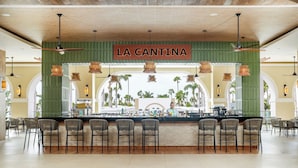 A bar area named "LA CANTINA" with a counter, bar stools, and hanging lights. - Riu Flamingos - All Inclusive (Nuevo Nayarit)