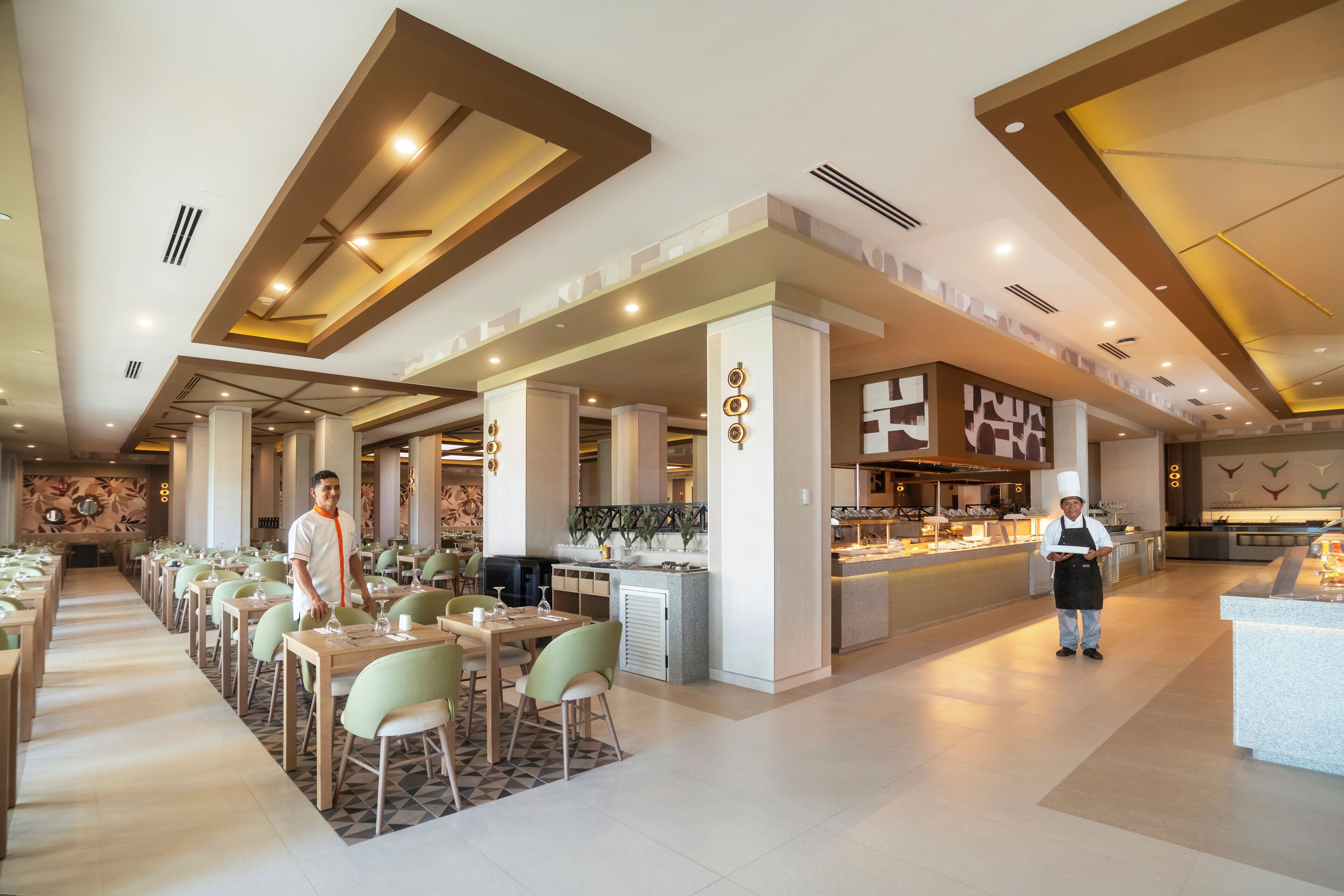 A spacious restaurant with high ceilings, modern lighting, and a central bar area.