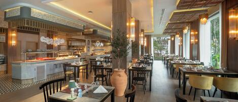 A modern restaurant with a central bar, multiple dining tables, and a large decorative vase.