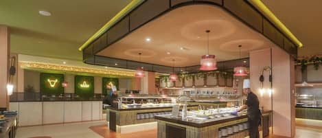A modern restaurant with a curved ceiling, a central serving counter, and a seating area with a herringbone floor pattern.