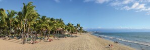 On the beach, sun loungers, beach towels, windsurfing
