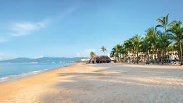 On the beach, sun loungers, beach towels, windsurfing