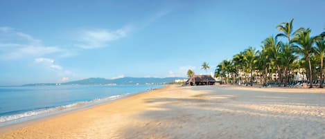 On the beach, sun-loungers, beach towels, windsurfing