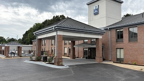 A hotel with a covered entrance, brick exterior, and a sign indicating it is a Best Western hotel. - Best Western Spartanburg I-26 (Spartanburg)