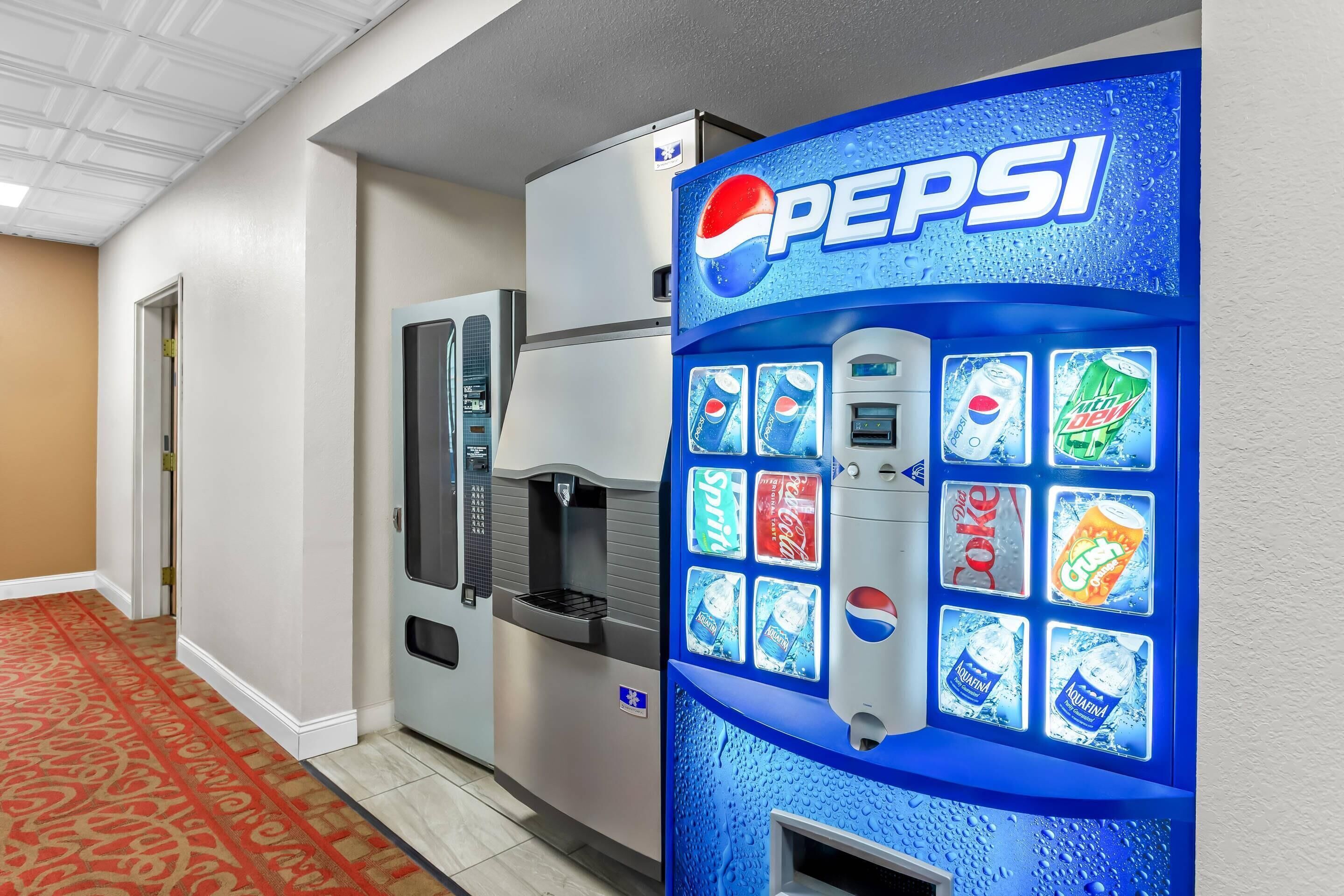 A vending machine with a Pepsi logo, offering various drinks including Sprite, Coca-Cola, Diet Coke, and Aquafina water.
