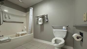 A bathroom with a bathtub, toilet, and shower.