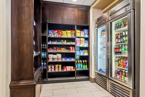 Un refrigerador repleto de aperitivos y bebidas, con diversas opciones de comida y refrescos.