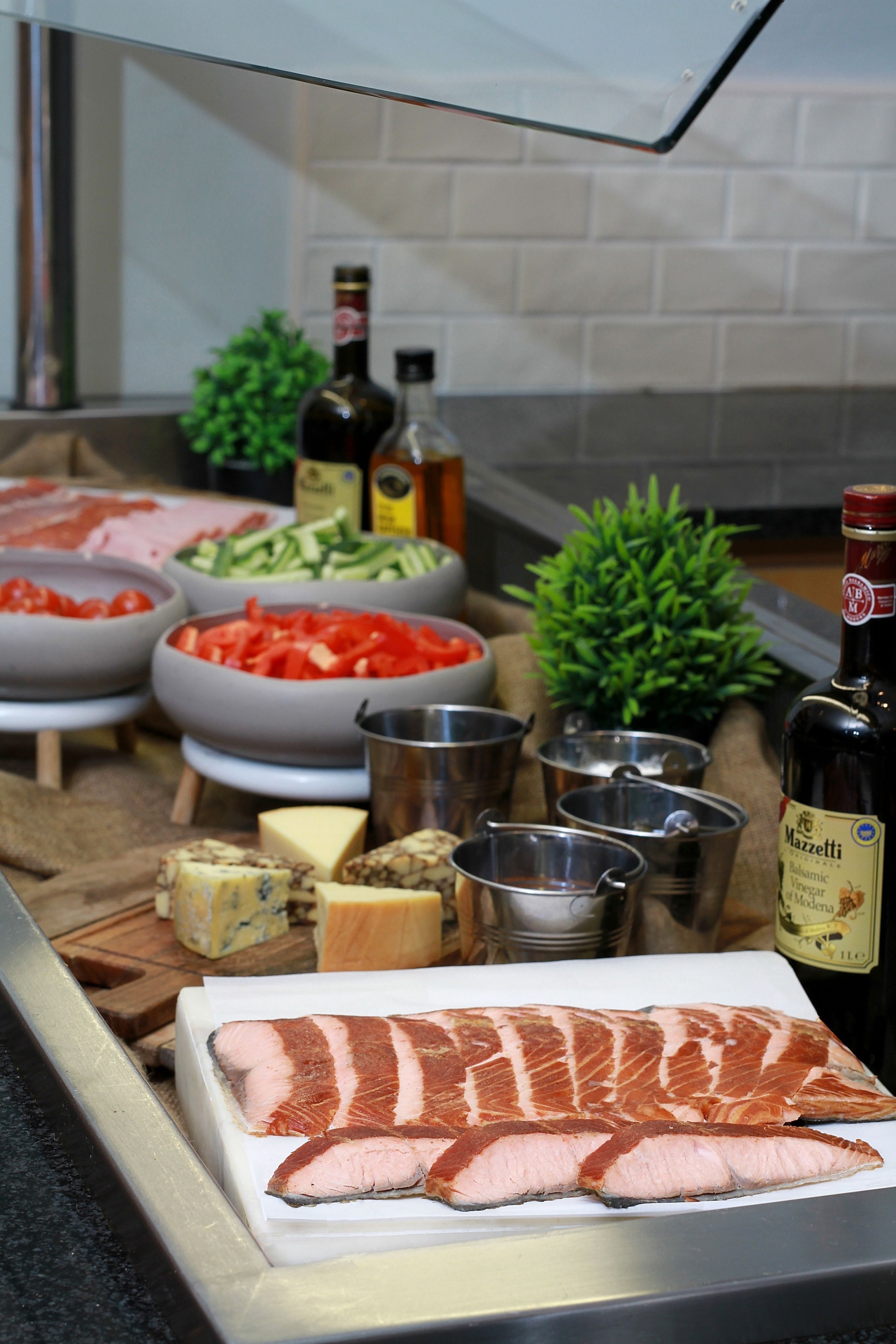 A kitchen counter with various food items and cooking utensils.