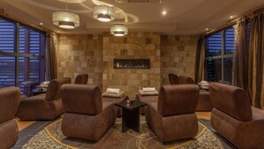 A modern lounge with leather sofas, a fireplace, and large windows. - Radisson Blu Hotel & Spa, Limerick (Cratloe)