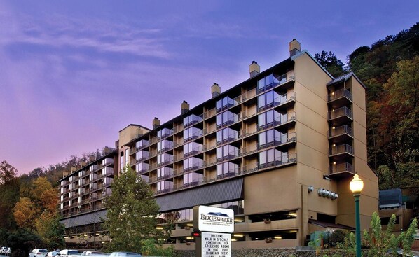A multi-story hotel with balconies, a sign indicating it is the Edgewater Hotel & Conference Center, and a parking area in front. - Edgewater Hotel - Gatlinburg (Gatlinburg)