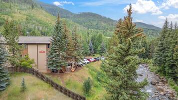 A lodge with a parking area and a river nearby.