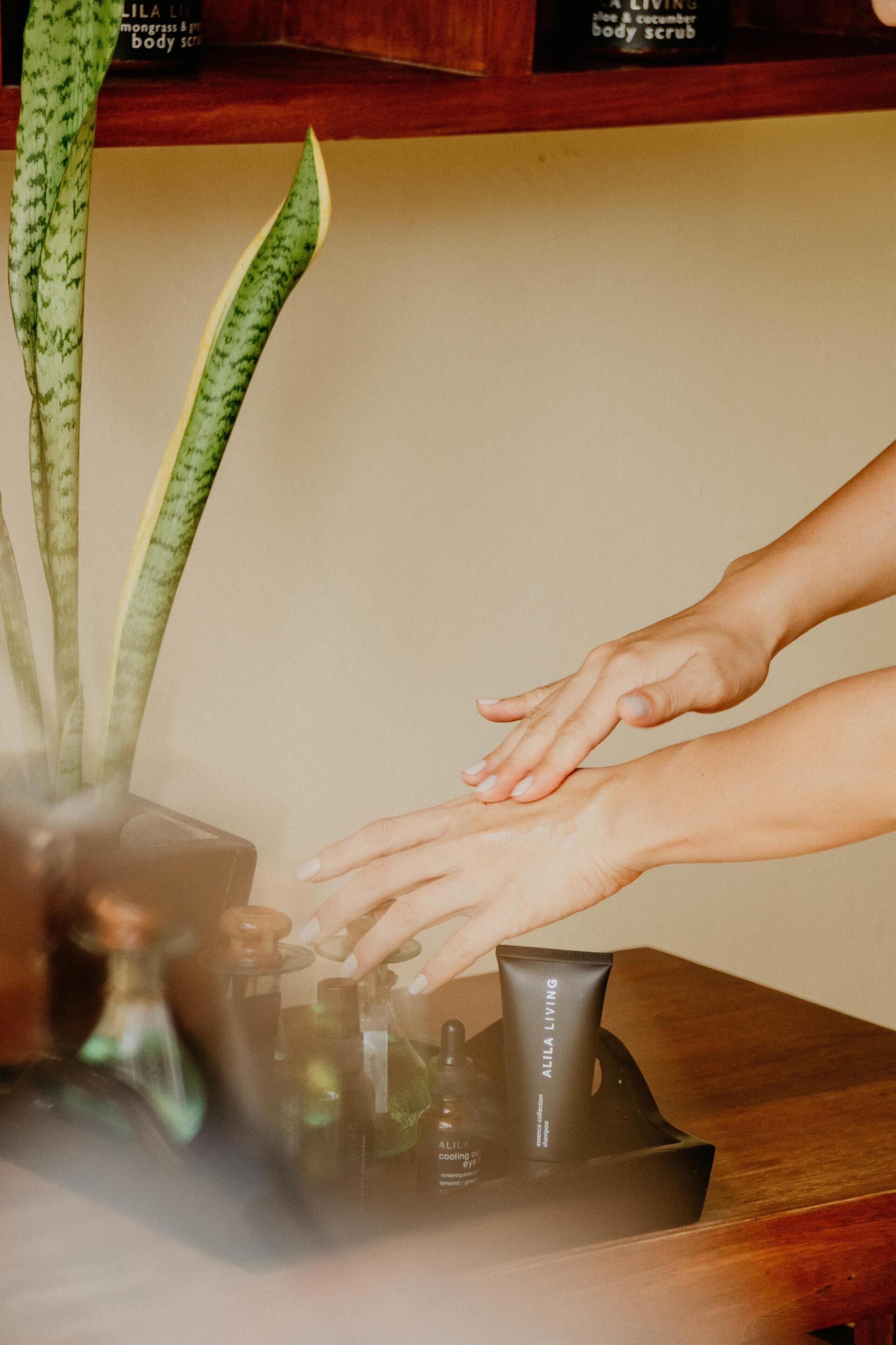 A person receiving a massage with a plant in the background.