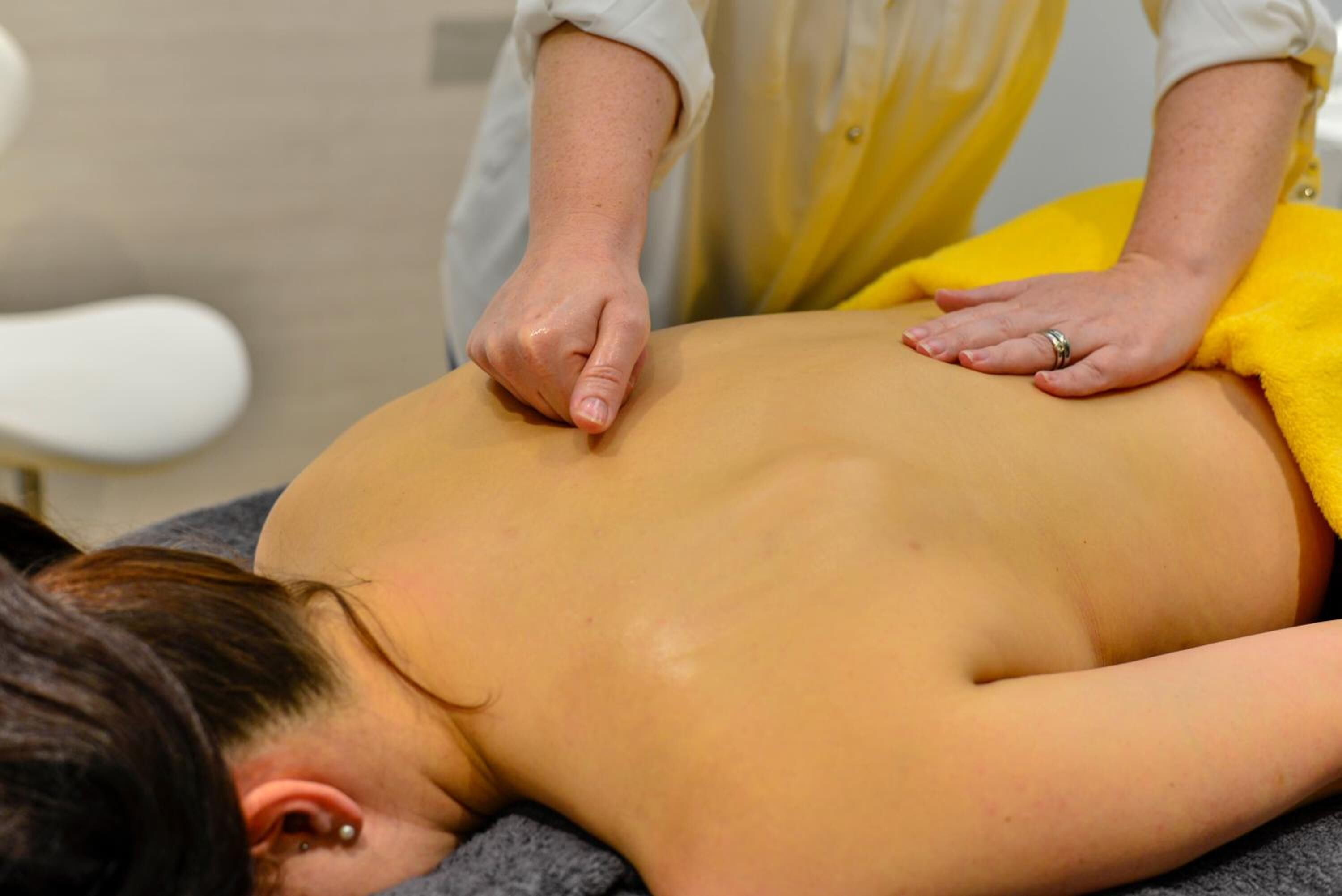 A person receiving a back massage.