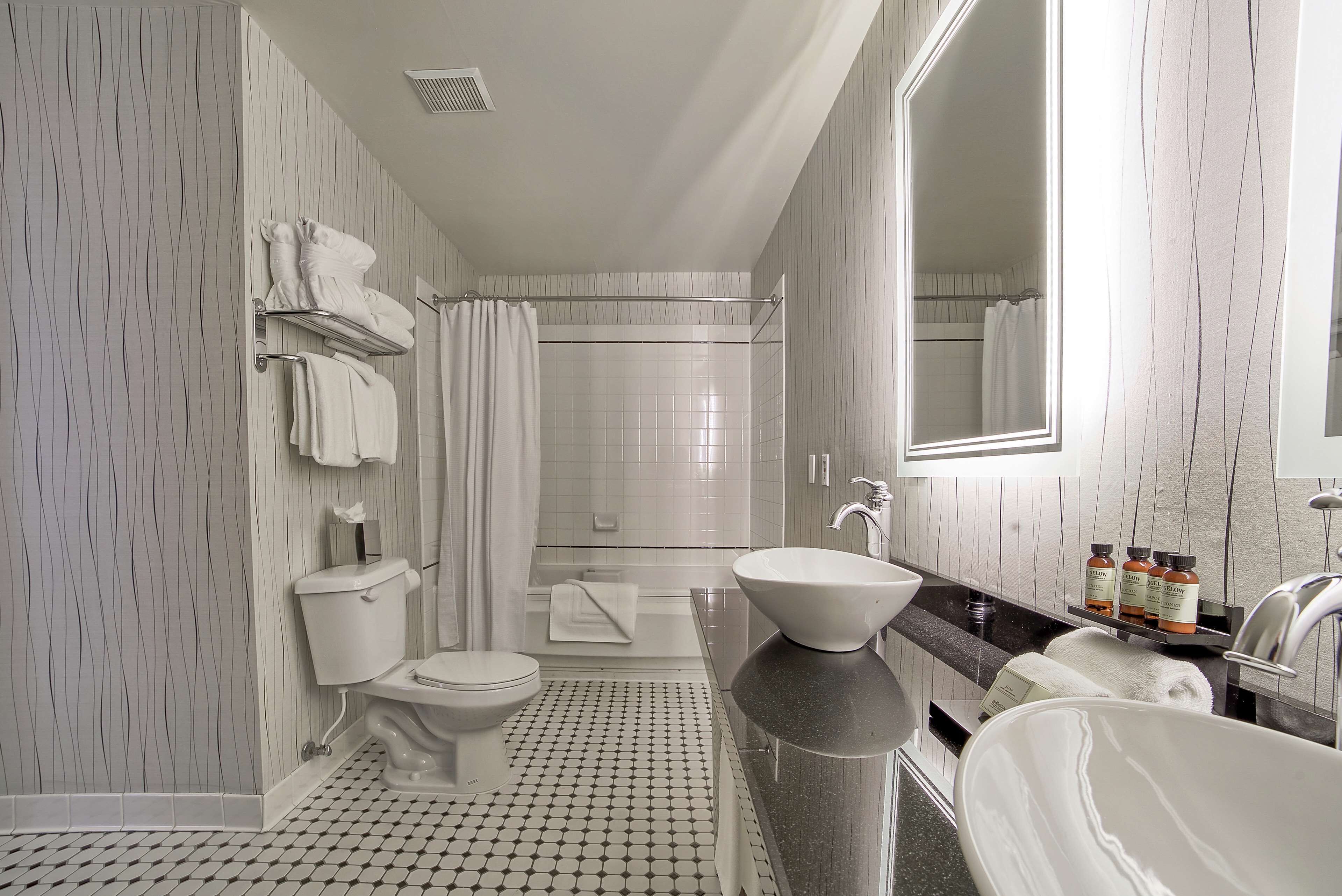 combined shower/bathtub, designer toiletries, hair dryer, bathrobes