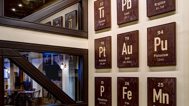 A staircase with a wall displaying the periodic table of elements. - Tapestry by Hilton The Peery Salt Lake City Downtown, UT (Salt Lake City)