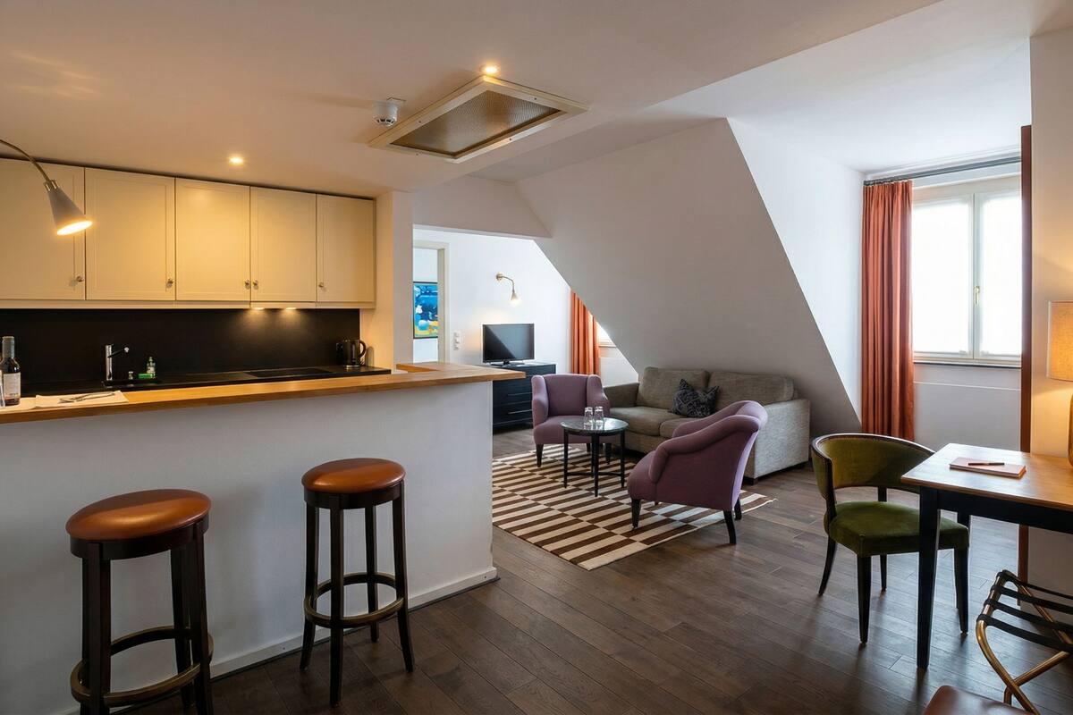 A modern apartment with a kitchen, dining area, and living room.