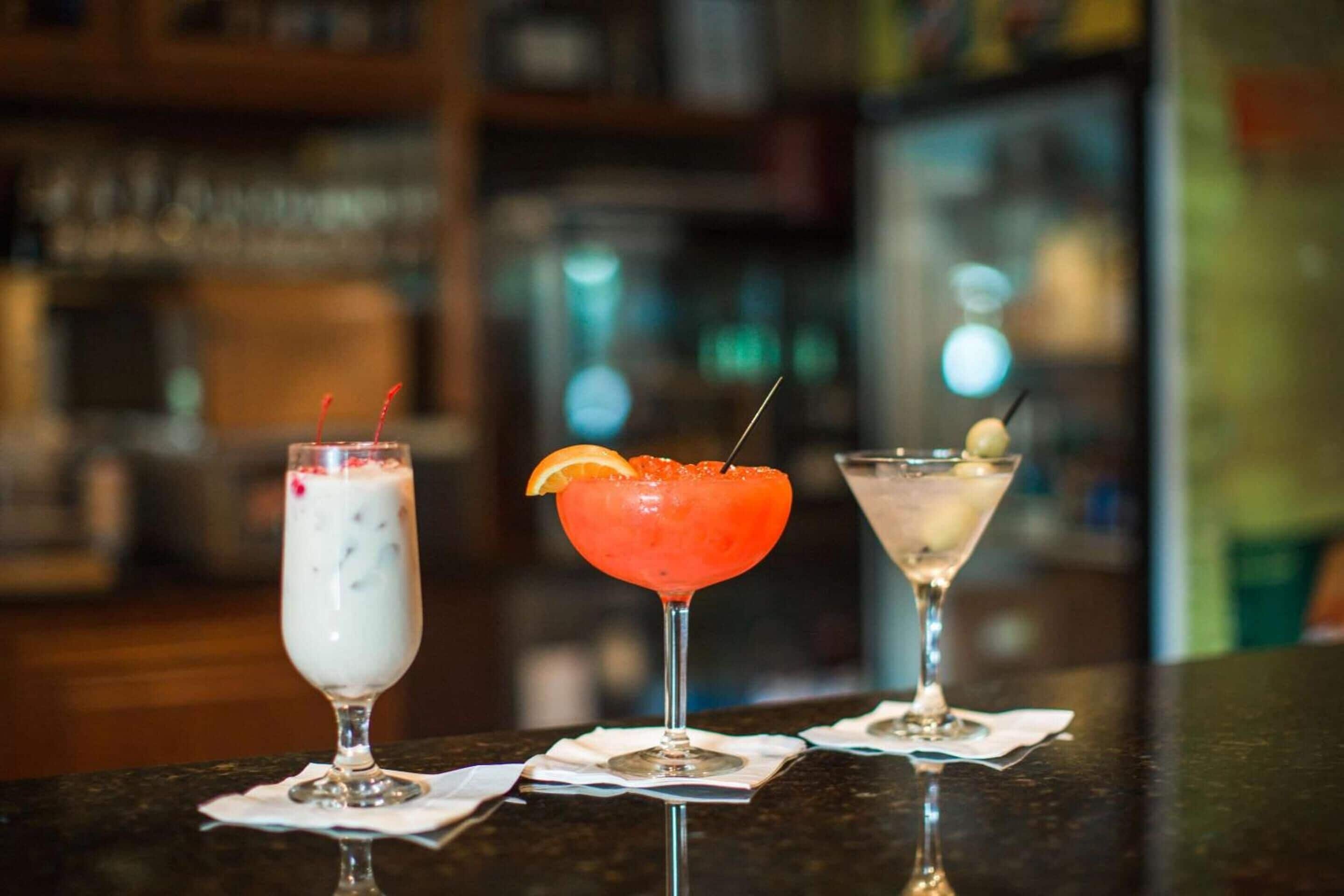 Three drinks on a bar counter.