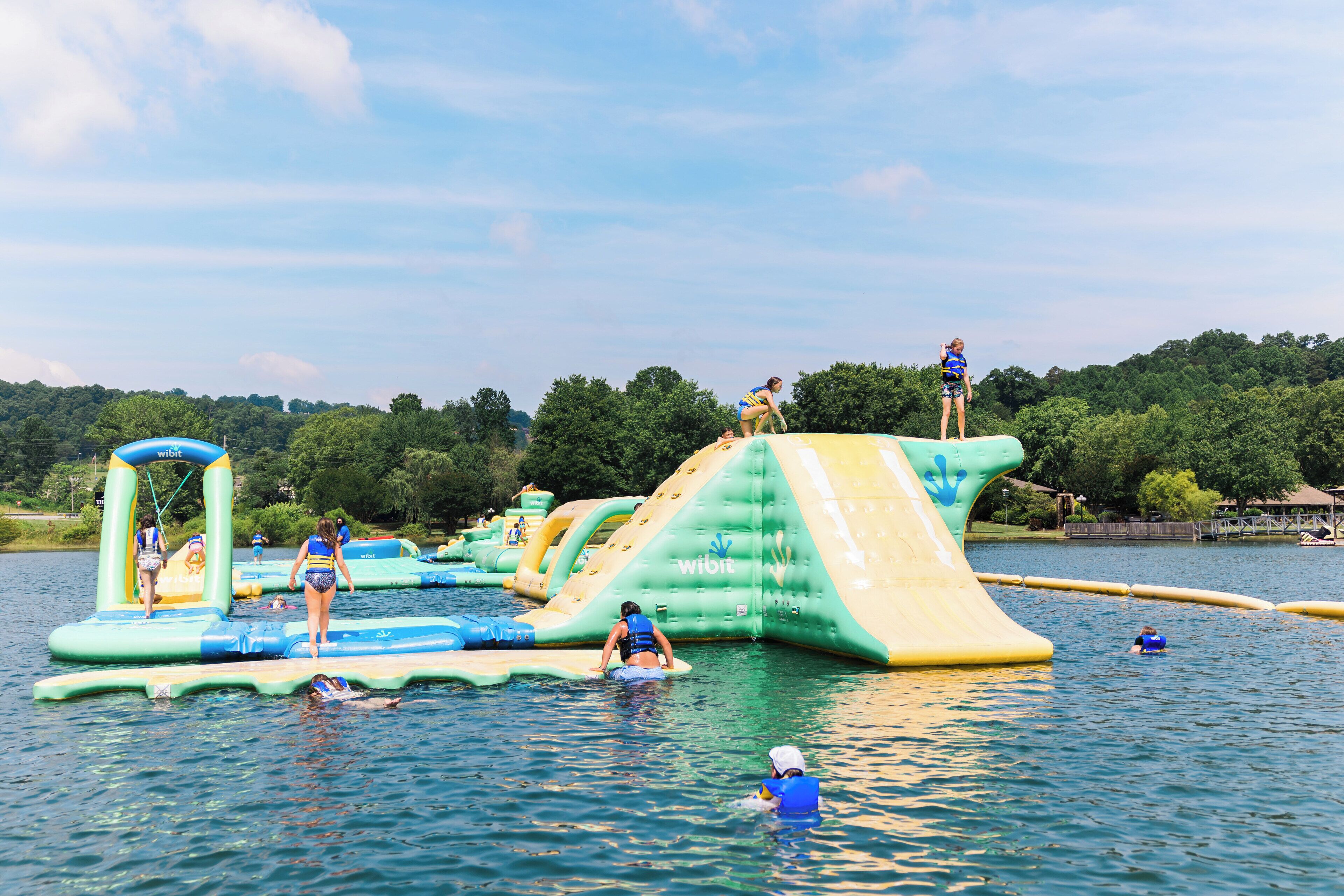 An inflatable water park with various play structures and slides.