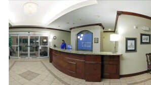 A reception area with a glass door entrance, a reception desk, and a wall-mounted information board. - Holiday Inn Express Hotel & Suites Murphy by IHG (Murphy)