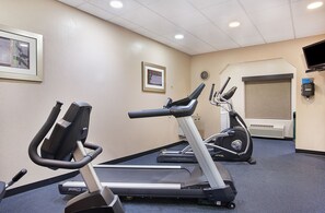 A gym with treadmills, stationary bikes, and a wall-mounted TV. - Holiday Inn Express Hotel & Suites Murphy by IHG (Murphy)