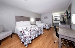 A hotel room with two beds, a desk, a chair, a mirror, and a television. - Red Roof Inn Bay Minette (Bay Minette)