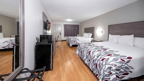 A hotel room with two beds, a desk, a chair, and a television. - Red Roof Inn Bay Minette (Bay Minette)