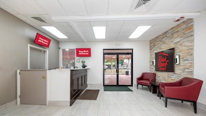 A reception area with a desk, chairs, and a wall-mounted sign indicating free Wi-Fi availability.
