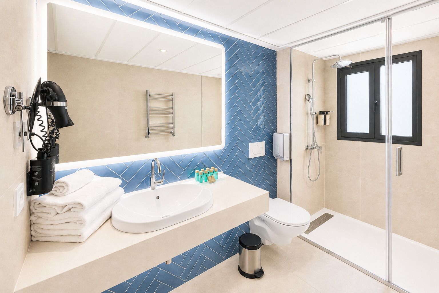 A modern bathroom with a large mirror, a sink, a toilet, and a shower area.
