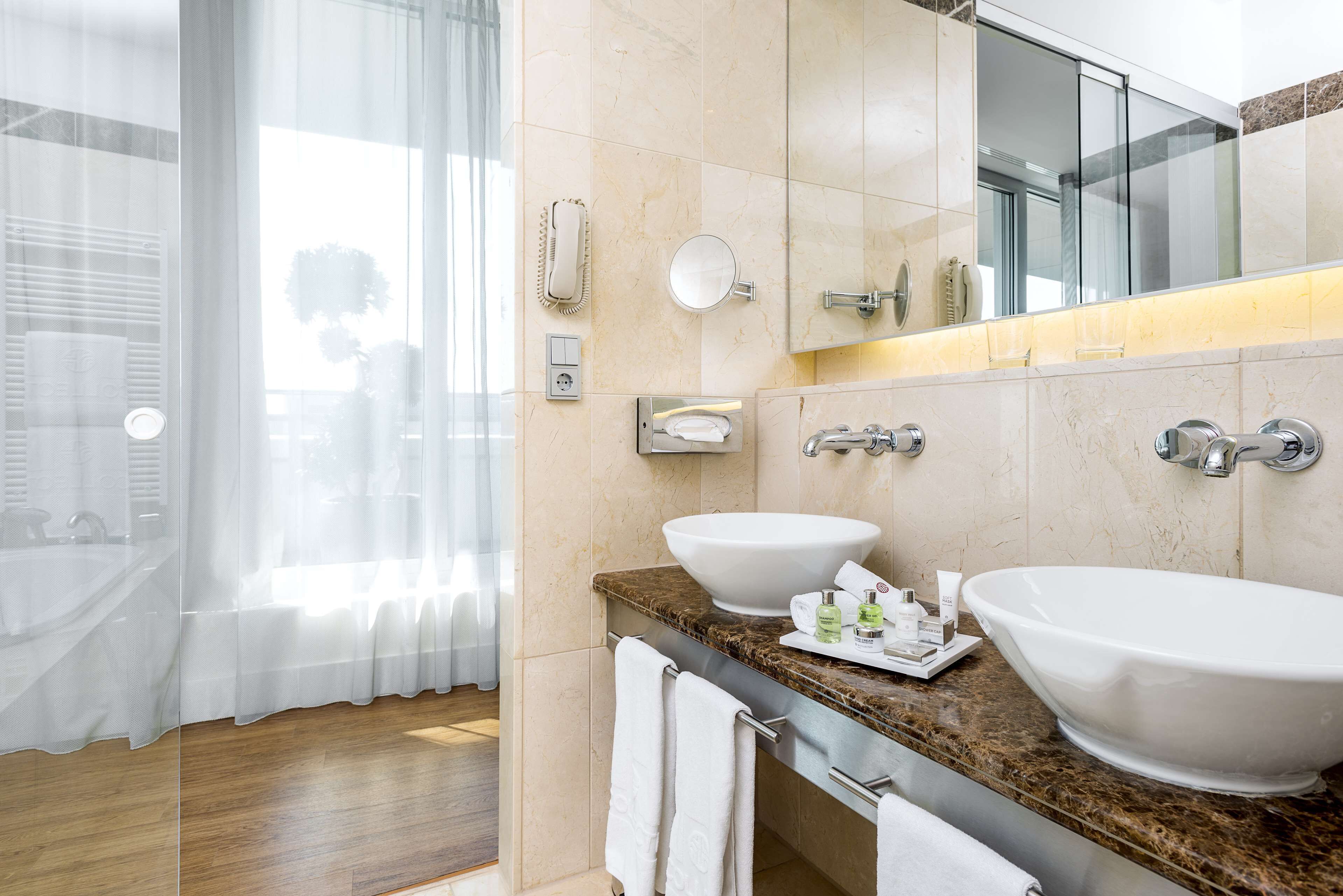 combined shower/bathtub, eco-friendly toiletries, hair dryer, bathrobes