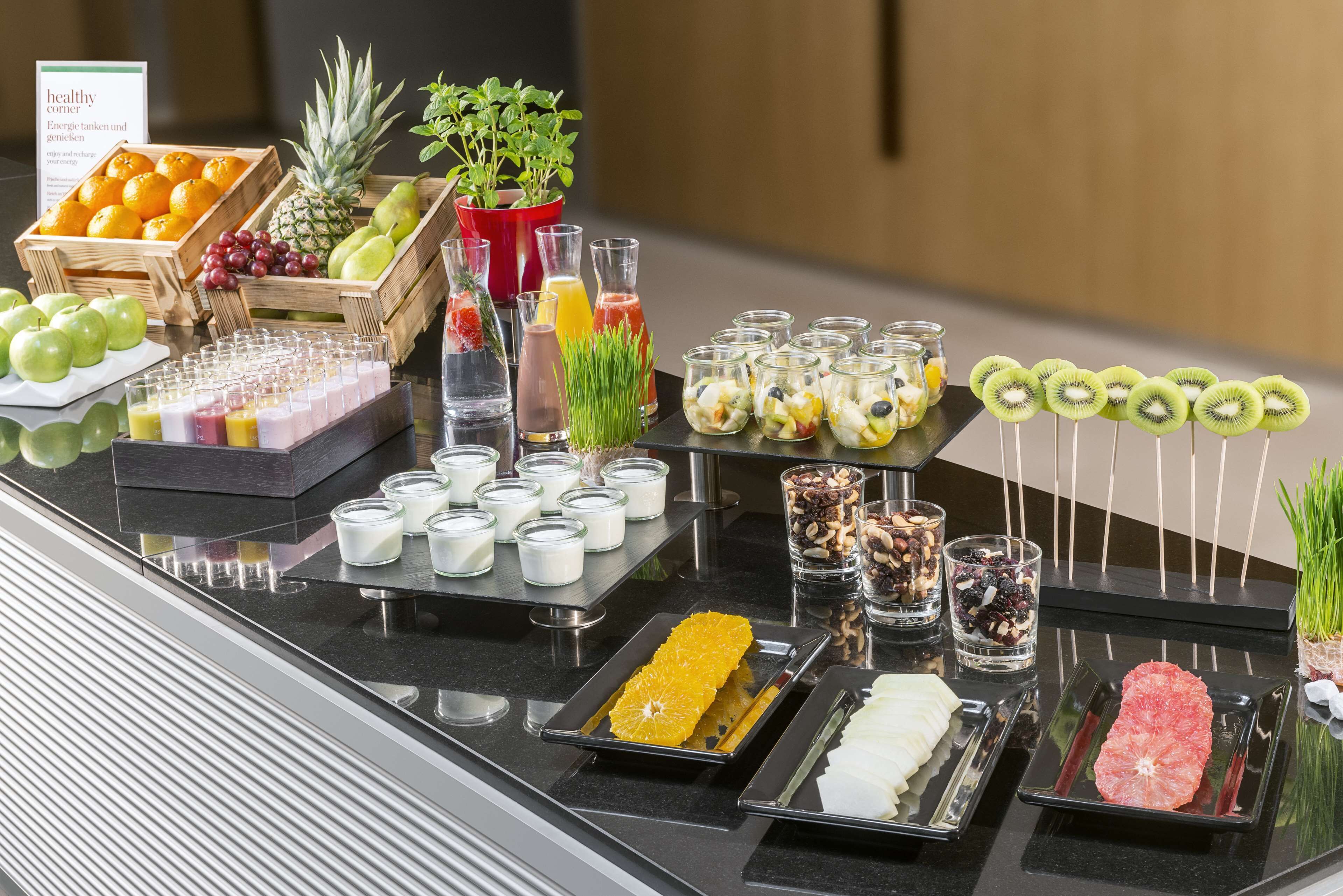 A buffet with fruits, juices, and various food items.