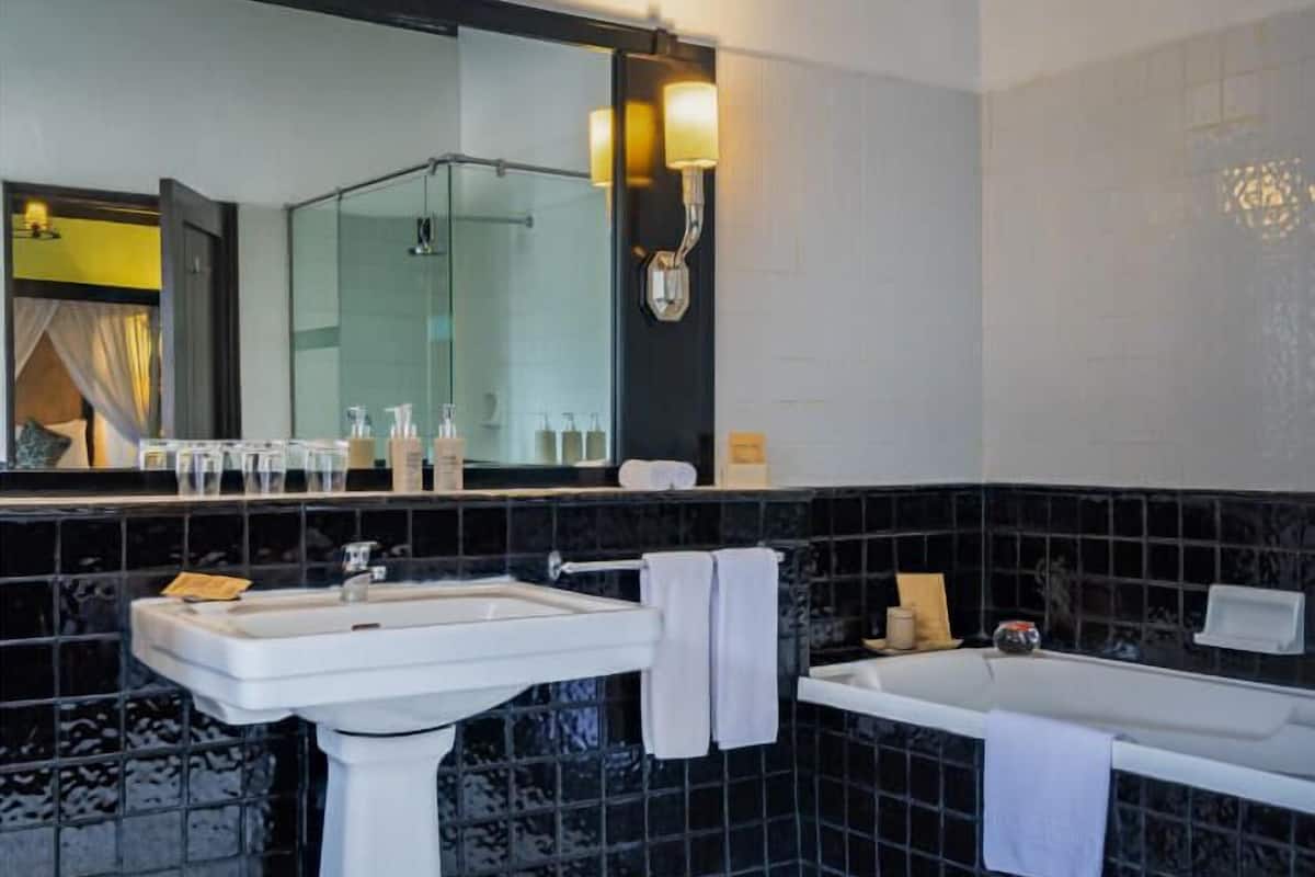family suite | bathroom | separate bathtub and shower, free toiletries, hair dryer, bathrobes