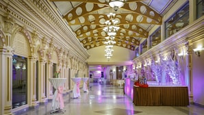 A grand hall with ornate columns, chandeliers, and a long reception area. - Hotel Shanker-Palatial Heritage Kathmandu (Kathmandu)