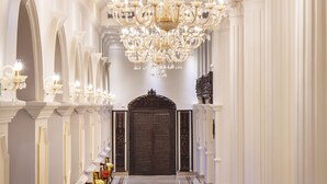 A grand hallway with a chandelier, columns, and a door at the end. - Hotel Shanker-Palatial Heritage Kathmandu (Kathmandu)