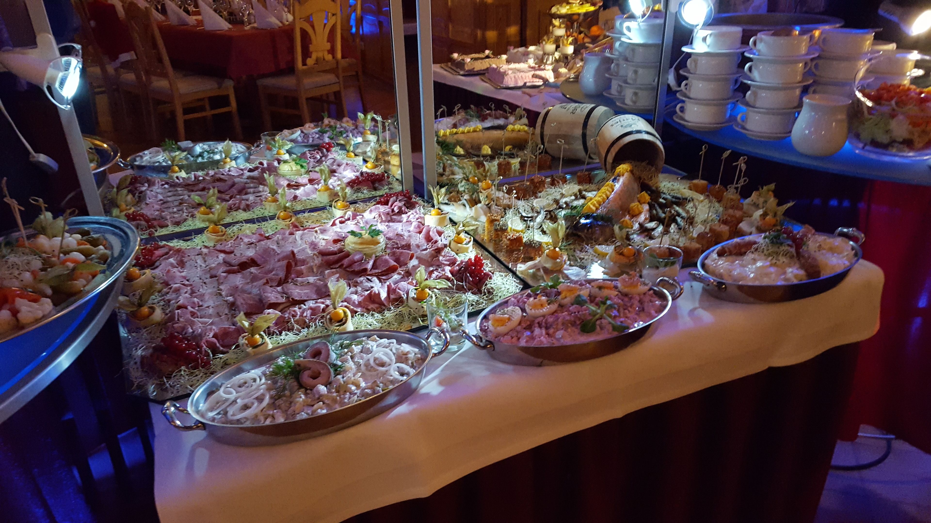 A buffet with various food items and a large metal container.