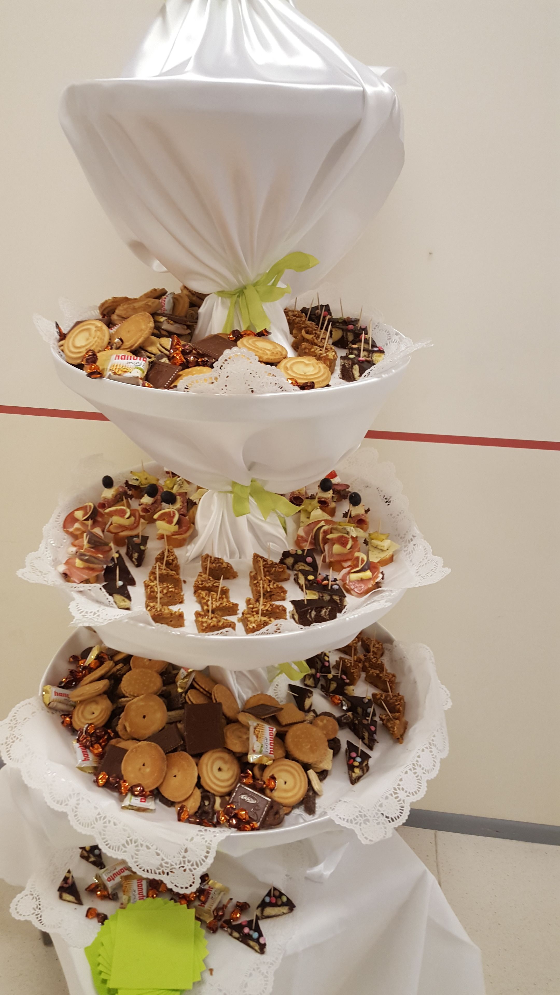 A multi-tiered dessert display with various sweets and snacks.