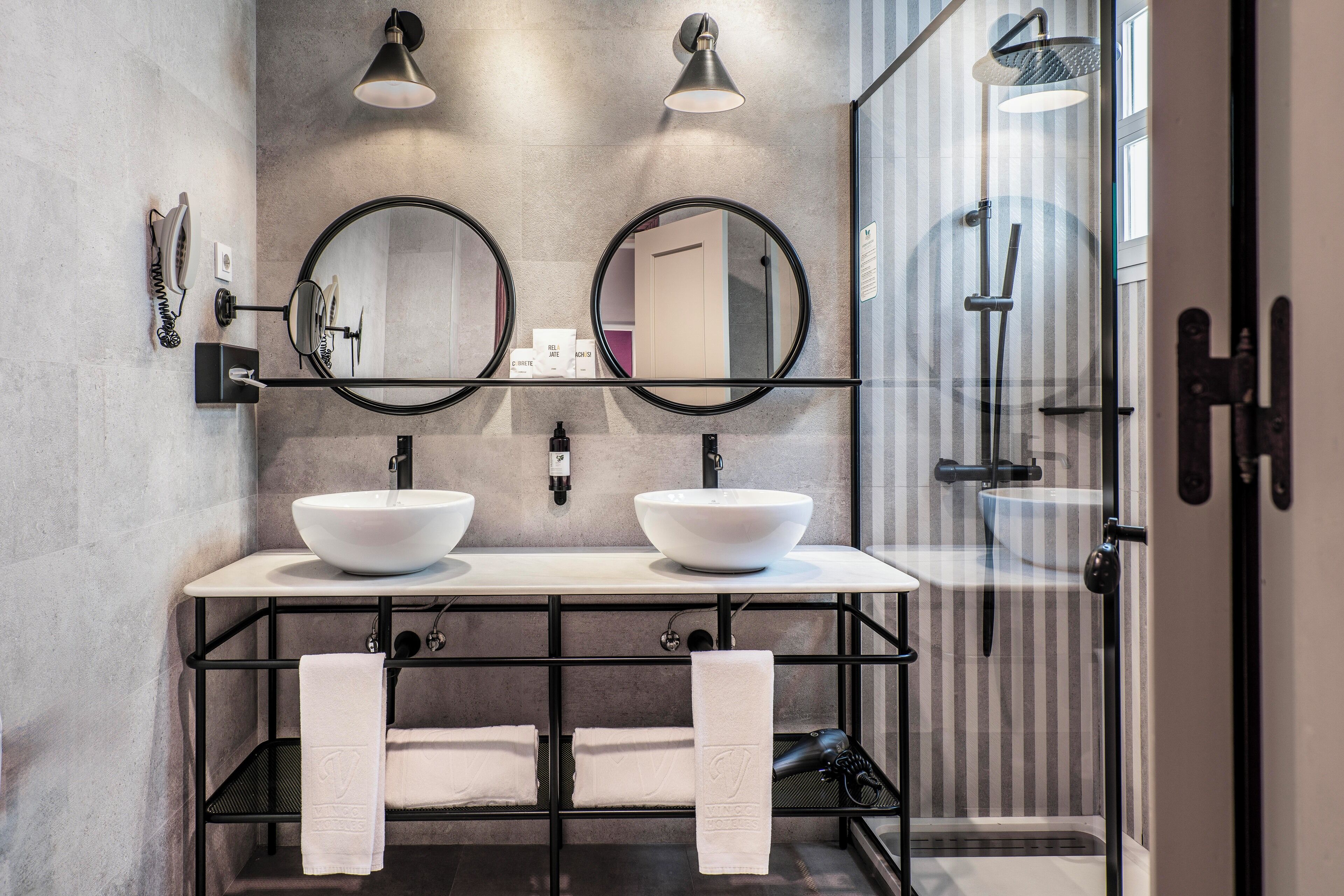 designer toiletries, hair dryer, towels, soap