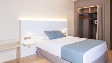 Un dormitorio moderno con cama, mesitas de noche y armario empotrado.