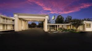 A hotel entrance with a covered walkway, a parking lot, and a sign indicating a Marriott hotel. - SureStay Hotel by Best Western Columbus Downtown (Columbus)